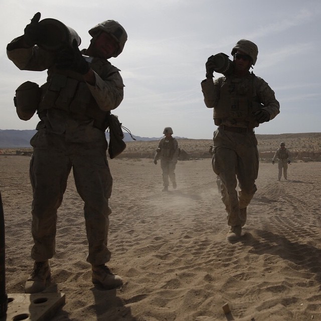 Marines carry 155mm artillery rounds during an assessment at MCAGCC Twentynine Palms
