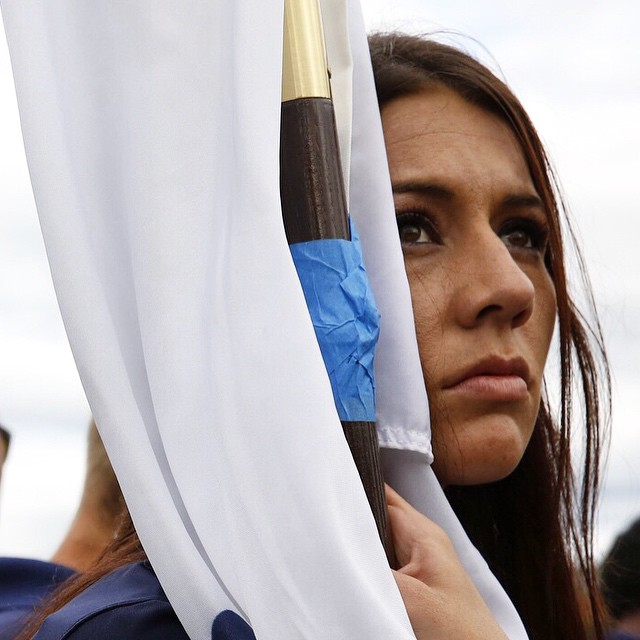 's Kristen Esget holds the  flag at the closing ceremony of  (Mike Morones/Military Times)