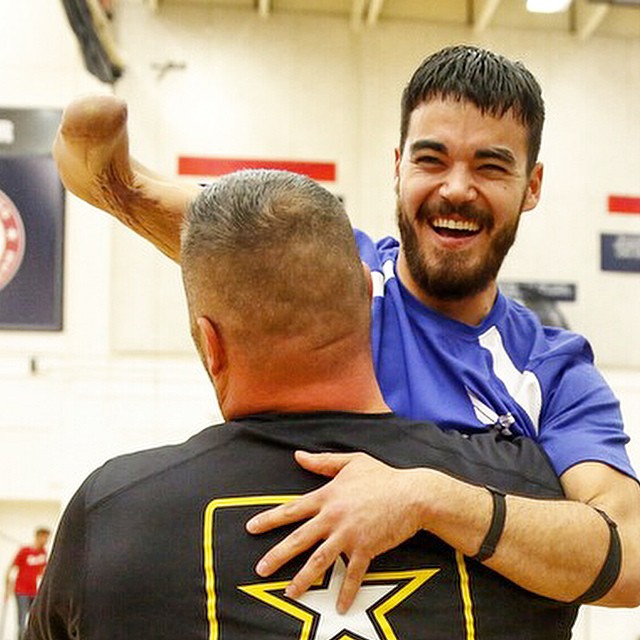 Army's Sean Hook celebrates with Air Force's Daniel Crane following the the team recurve archery match. Army own gold and a Air Force won silver