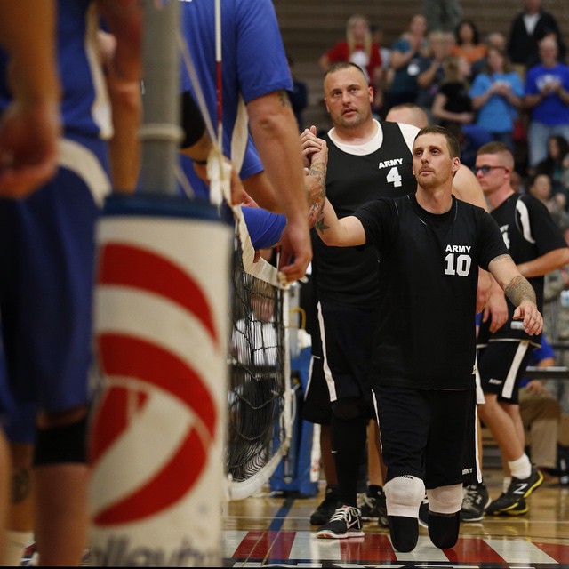 Retired Army Sgt. Matthew Spang congratulates the Air Force team following Army's loss in sitting volleyball at the